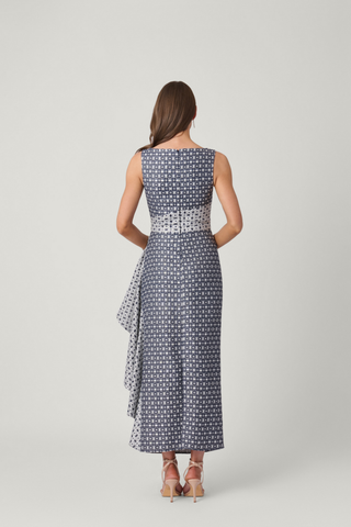 Shoshanna Catherine Dress in Silver and Indigo with sleeveless fitted bodice, patterned fabric, long skirt, and cascading side ruffle.