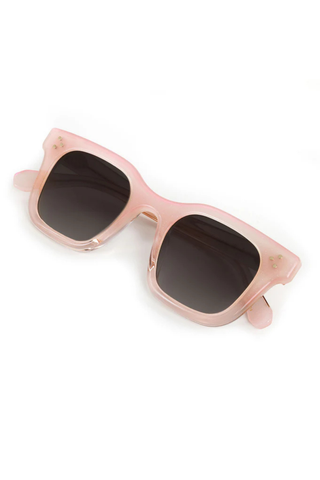 Rose gold sunglasses with dark lenses on a white background