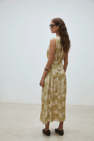Green sleeveless midi dress with abstract print, cinched waist, and flowy silhouette