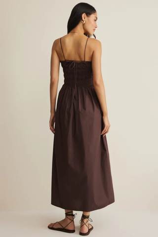 Model wearing Z Supply Cornelia Poplin Maxi Dress in Chocolate Cherry with a smocked bodice, square neckline, adjustable straps, and flowy cotton maxi skirt