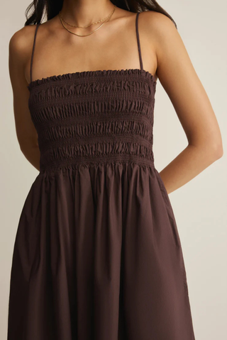 Model wearing Z Supply Cornelia Poplin Maxi Dress in Chocolate Cherry with a smocked bodice, square neckline, adjustable straps, and flowy cotton maxi skirt