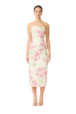 Woman wearing a strapless floral dress on a white background