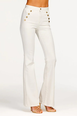 White high-rise flare jeans with gold button details by Ramy Brook