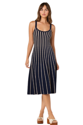 Model wearing the ASTR Irecia Sweater Dress in Navy Stripe featuring a scoop neckline, tank silhouette, soft knit fabric, and cream vertical stripes on a classic navy midi dress.