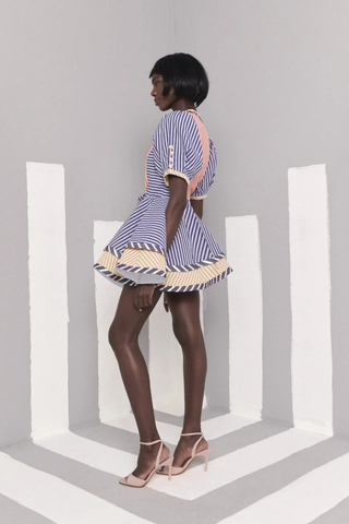 Celia B Kaen Dress in Multi featuring mixed stripe prints, puff sleeves, front zipper detail, and dramatic flared mini silhouette