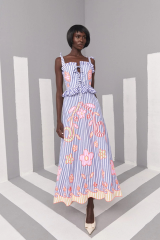 Celia B Kailen Dress in Multi featuring blue striped cotton fabric, colorful floral embroidery, ruffle trim, and tie shoulder straps