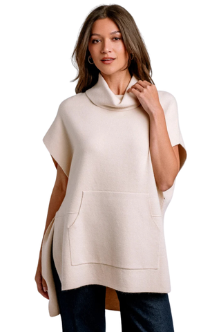 Kerisma Kanga Poncho in Ecru featuring a relaxed draped silhouette, high neckline, short sleeves, and side slit details.