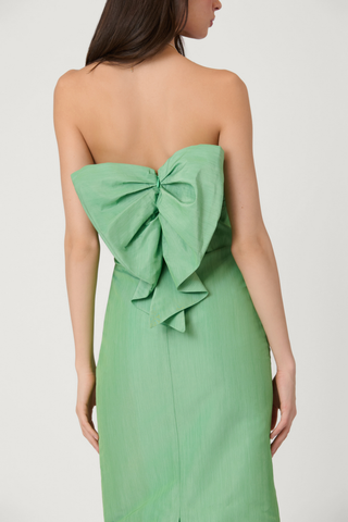 Strapless sage green midi dress with smocked ruched bodice and slim column silhouette, shown on model against white background.