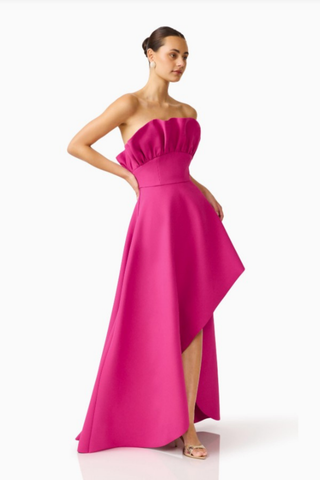 Elliatt Liora Asymmetric Gown in Pink Orchid featuring a strapless neckline, asymmetric draped overlay, and front slit.