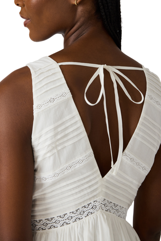 White cotton high-low maxi dress with lace trim, pintuck detailing, and open tie back by Steve Madden