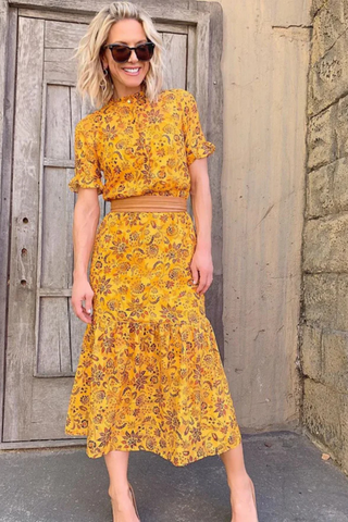 ADA Collection tan midi wrap leather belt styled tied at the waist over dress