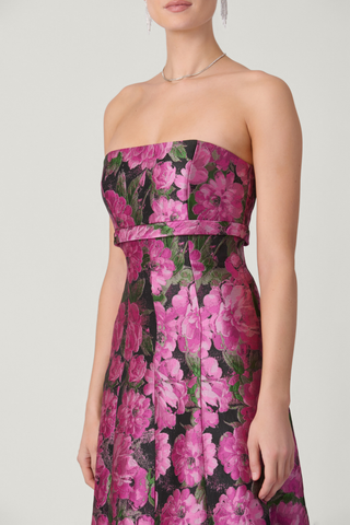 Shoshanna Nia Dress in Magenta Multi featuring floral jacquard, strapless fitted bodice, and floor-length flared skirt with ruffle detailing.