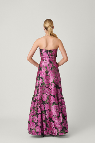 Shoshanna Nia Dress in Magenta Multi featuring floral jacquard, strapless fitted bodice, and floor-length flared skirt with ruffle detailing.