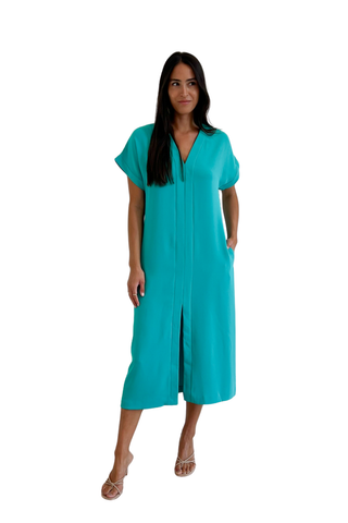 Woman wearing a tropical teal midi dress with short sleeves and relaxed silhouette from Trina Turk on a white background.