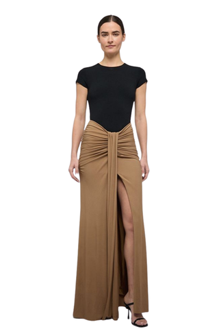 SIMKHAI Matilde Gown in Black Multi featuring a fitted black bodice, gathered waist, printed maxi skirt, and front slit.