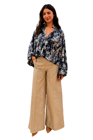 Raiment Birdie Pant in Wax Paper Tan featuring a high-rise waist, front patch pockets, and relaxed full-length wide-leg silhouette.