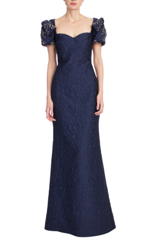 Badgley Mischka Knot Sleeve Jacquard Gown in navy featuring a sweetheart neckline, crystal-embellished puff sleeves, and mermaid silhouette.