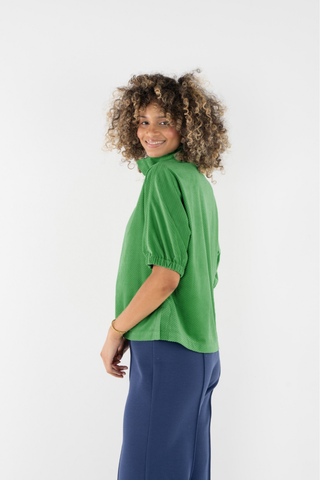 Emily McCarthy Bonny Top in Winter Pine featuring a vibrant green color, collared neckline, button front, and short puff sleeves.