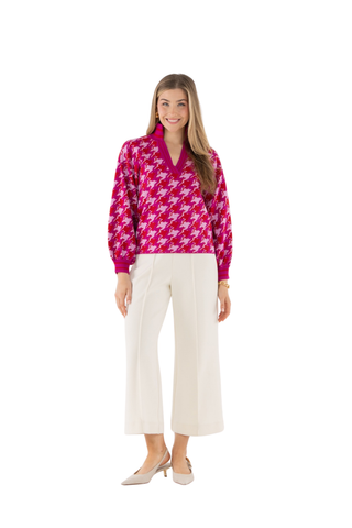 Emily McCarthy Lolli Sweater in Houndstooth featuring a vibrant pink and red houndstooth pattern, V-neckline, and long sleeves.