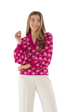 Emily McCarthy Lolli Sweater in Houndstooth featuring a vibrant pink and red houndstooth pattern, V-neckline, and long sleeves.