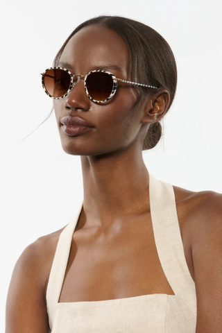 KREWE Tate Sunglasses in Domino 18K featuring round black-and-ivory acetate frames with amber gradient lenses and gold-plated hardware
