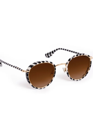 KREWE Tate Sunglasses in Domino 18K featuring round black-and-ivory acetate frames with amber gradient lenses and gold-plated hardware
