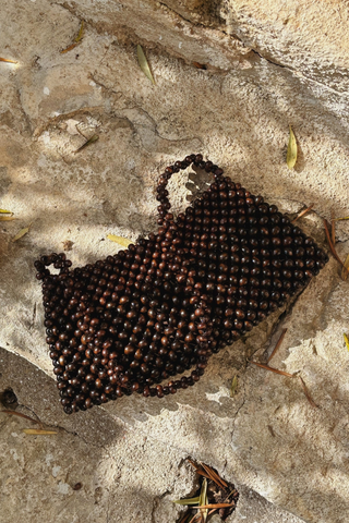 Bembien Terra Bag in brown made of polished wood beads with single shoulder strap and small structured silhouette